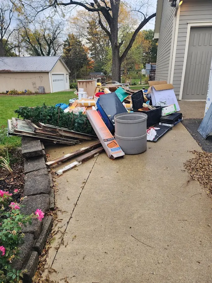 Dumpster being loaded with debris for 10 Yard Dumpster Rental in North East